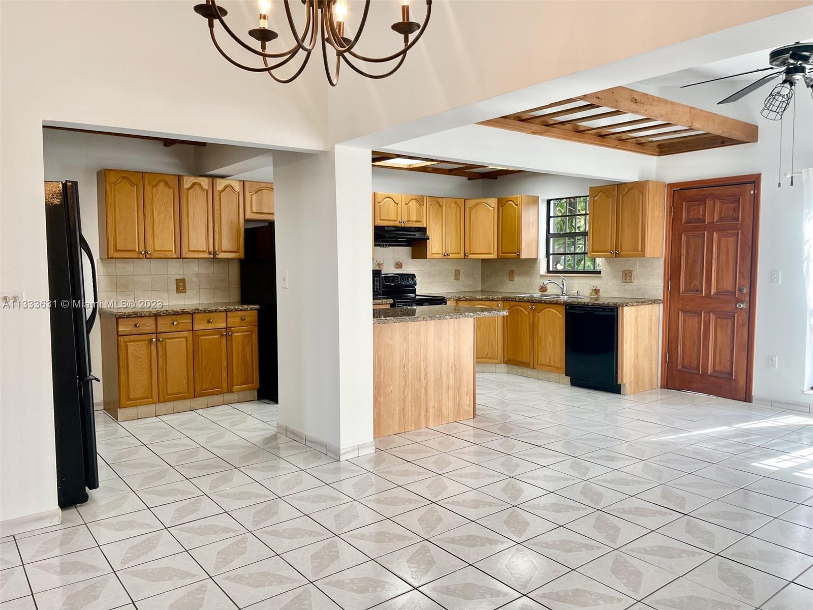 8600 Southwest 33rd Terrace Miami, FL 33155 - Photo 4 of 14 a kitchen with stainless steel appliances granite countertop a refrigerator and a sink