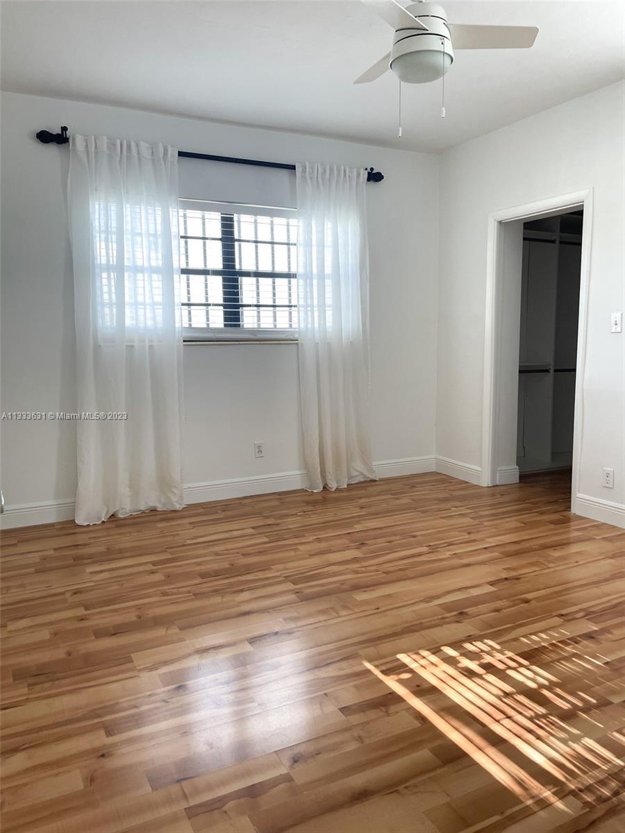 8600 Southwest 33rd Terrace Miami, FL 33155 - Photo 9 of 14 an empty room with wooden floor and windows