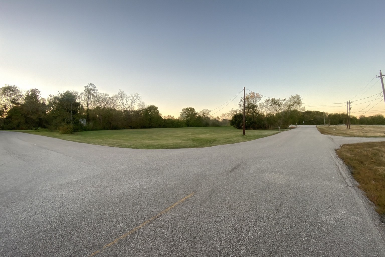 a view of a field with trees in background