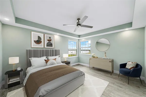 a bedroom with a large bed and wooden floor