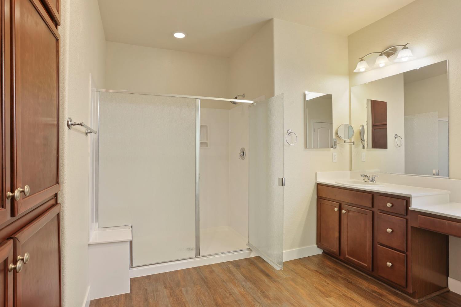 2364 Inyo Place Manteca, CA 95337 - Photo 23 of 69 a spacious bathroom with a double vanity sink a mirror and a shower
