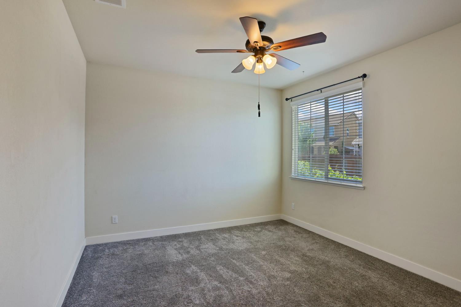 2364 Inyo Place Manteca, CA 95337 - Photo 36 of 69 an empty room with a window and a fan
