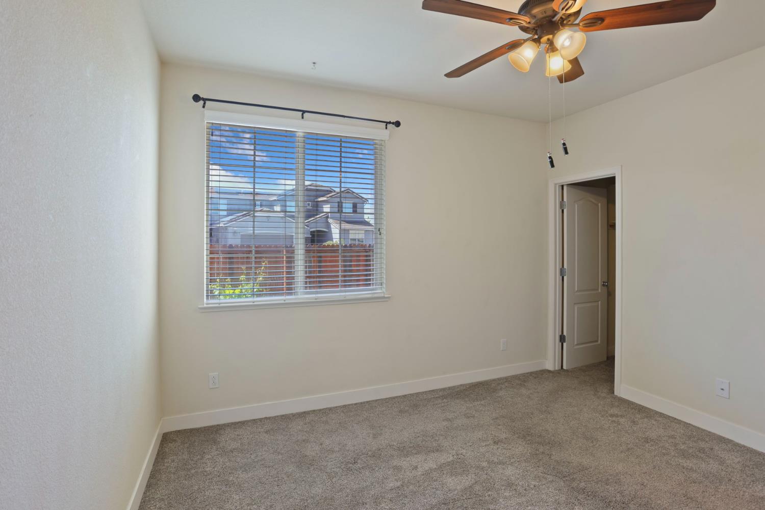 2364 Inyo Place Manteca, CA 95337 - Photo 37 of 69 an empty room with windows and fan