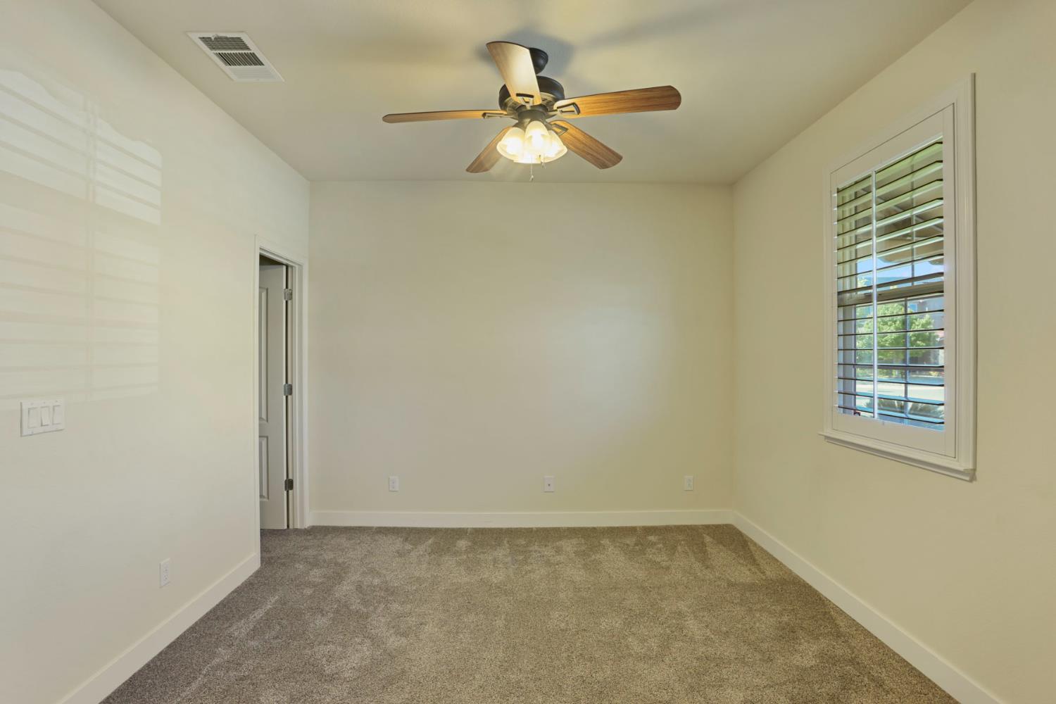 2364 Inyo Place Manteca, CA 95337 - Photo 43 of 69 an empty room with a window and a fan