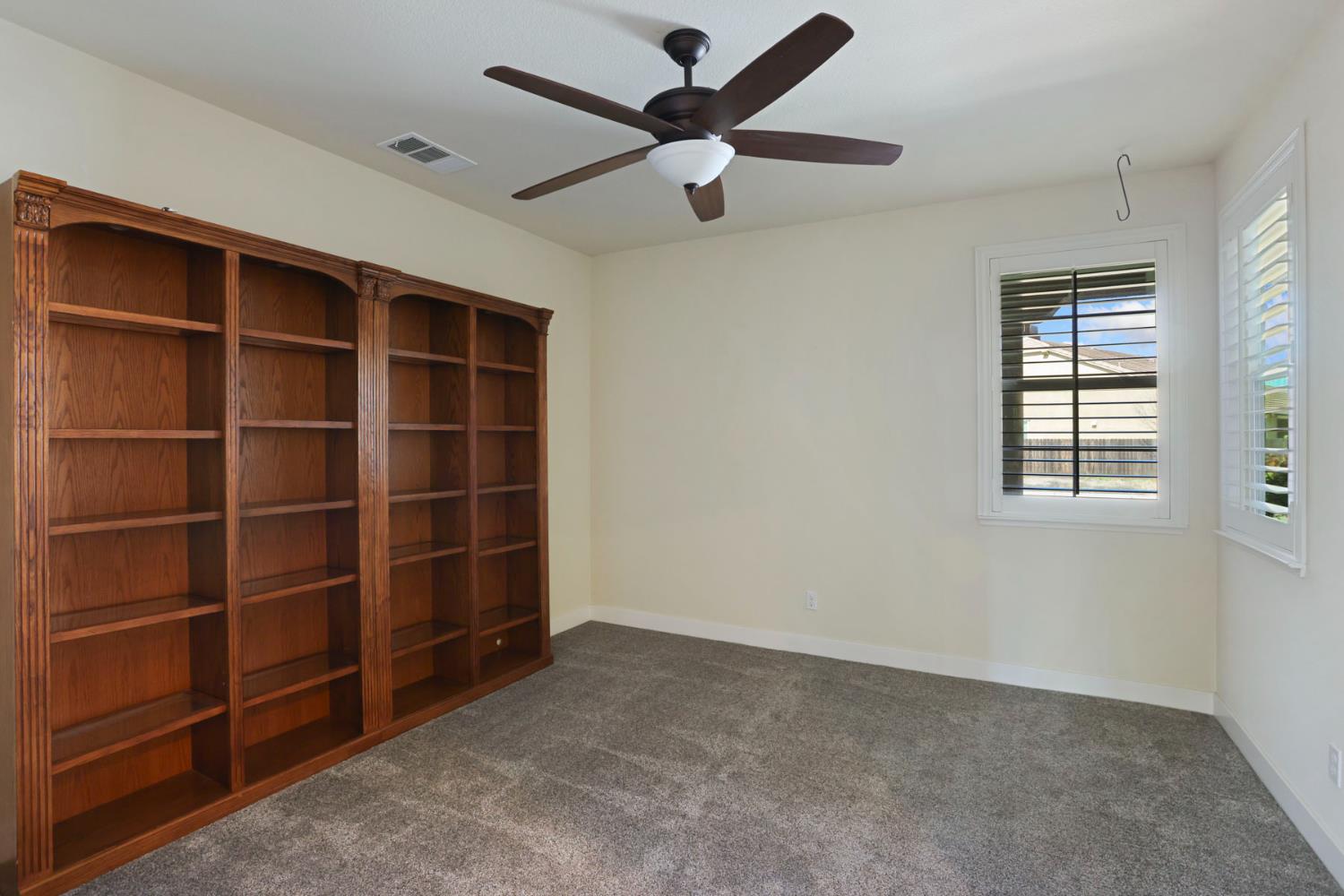2364 Inyo Place Manteca, CA 95337 - Photo 45 of 69 a view of an empty room with a window and a ceiling fan