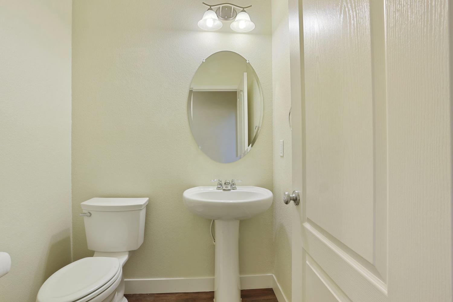 2364 Inyo Place Manteca, CA 95337 - Photo 9 of 69 a bathroom with a toilet sink and mirror