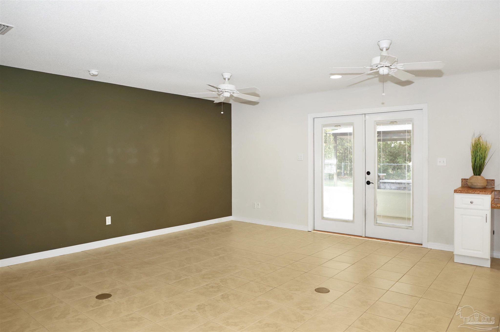 4454 Lyons Place Holt, FL 32564 - Photo 12 of 53 an empty room with a ceiling fan and bathroom