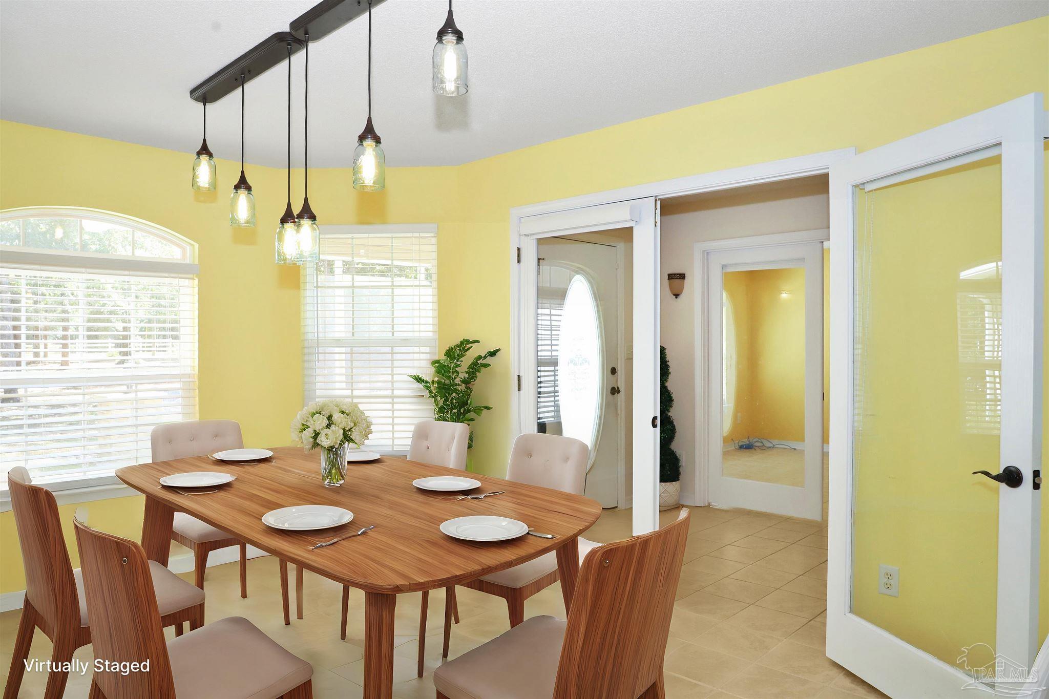 4454 Lyons Place Holt, FL 32564 - Photo 18 of 53 a view of a dining room with furniture and wooden floor