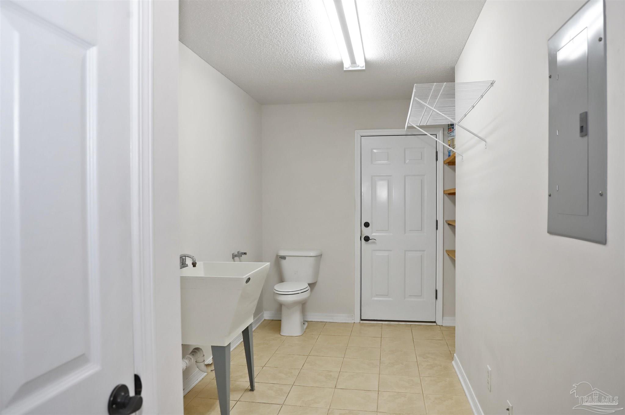 4454 Lyons Place Holt, FL 32564 - Photo 21 of 53 a bathroom with a toilet a sink and mirror