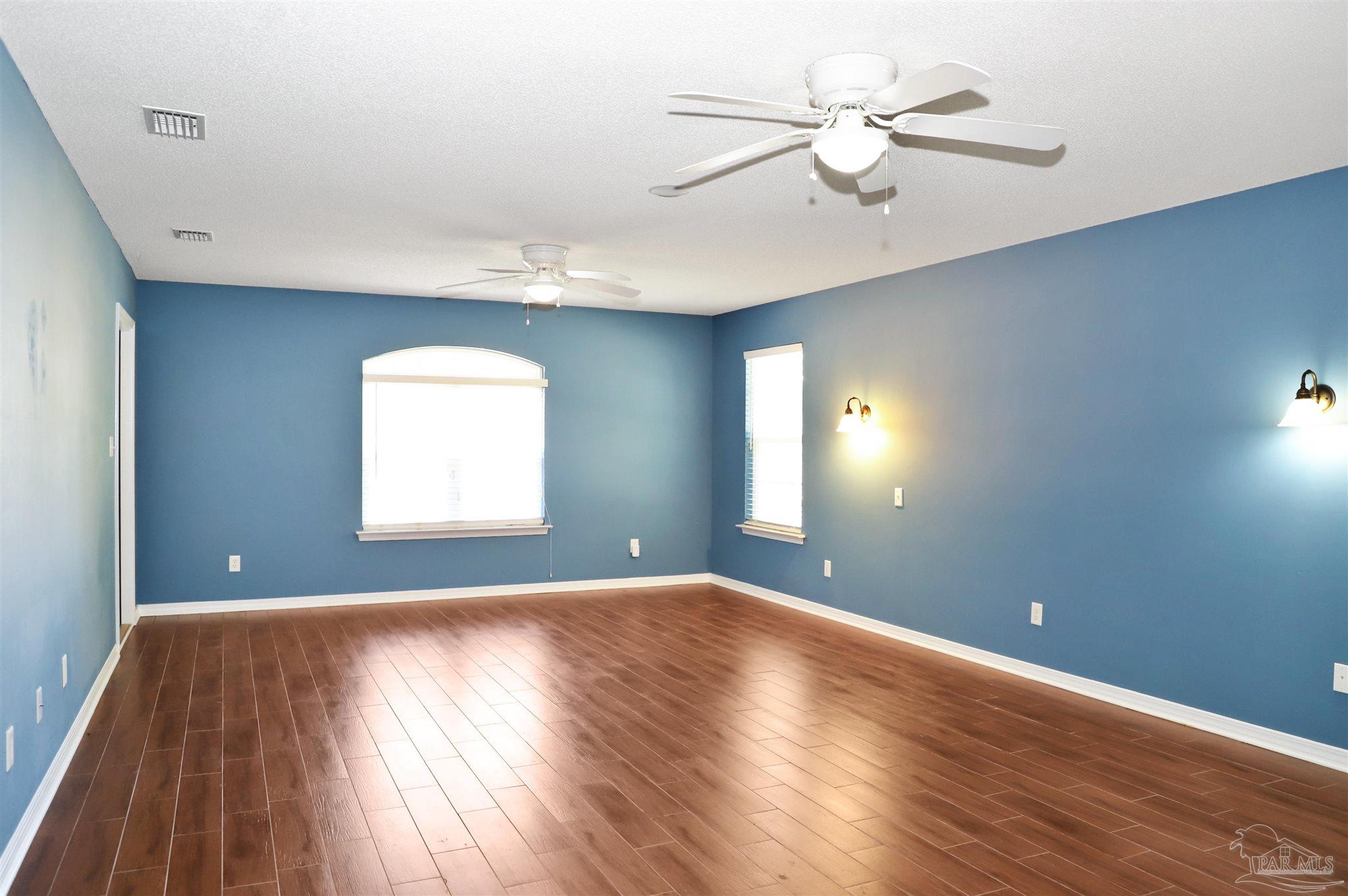 4454 Lyons Place Holt, FL 32564 - Photo 23 of 53 wooden floor in an empty room with a window