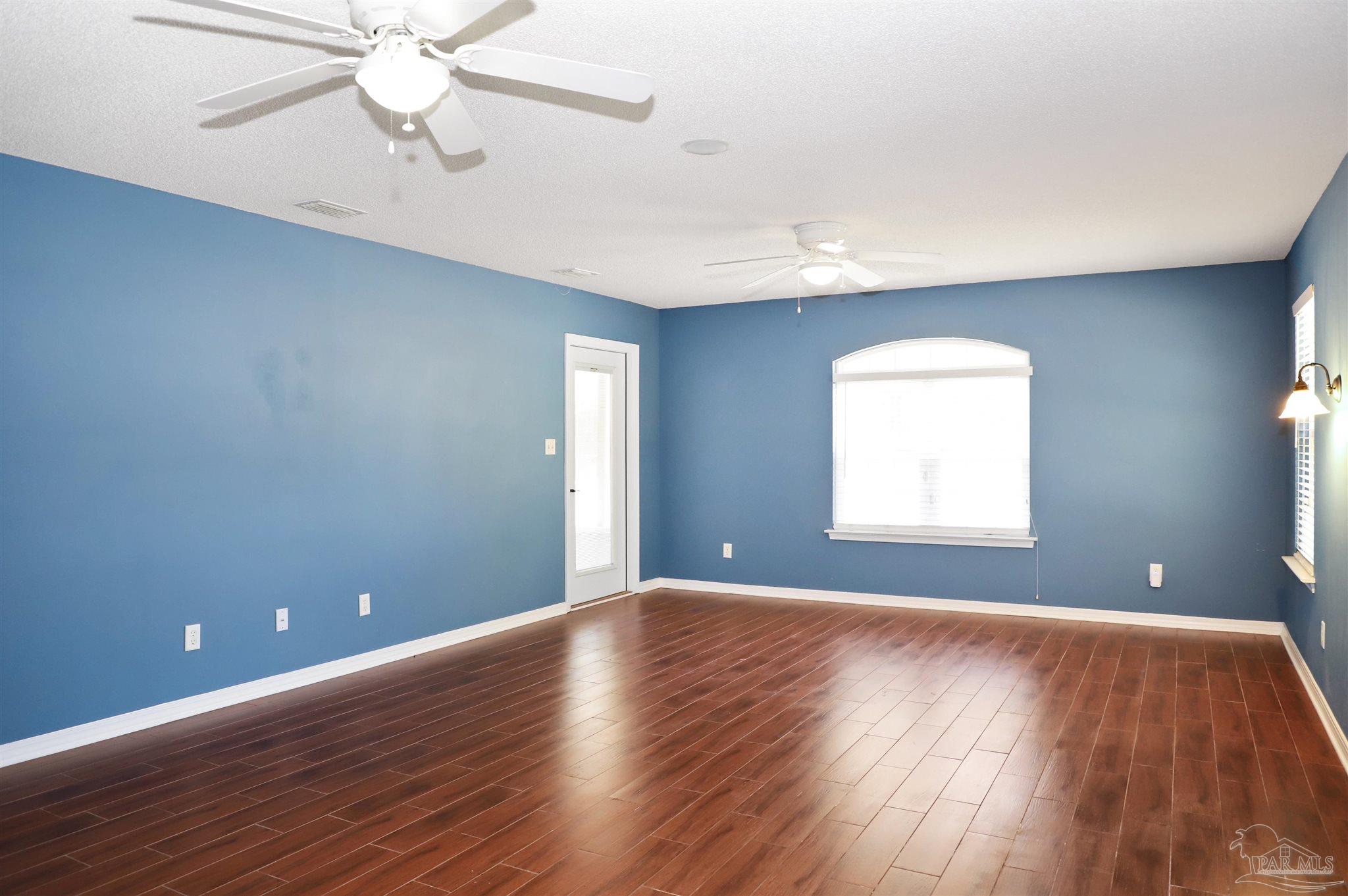 4454 Lyons Place Holt, FL 32564 - Photo 24 of 53 wooden floor in an empty room with a window