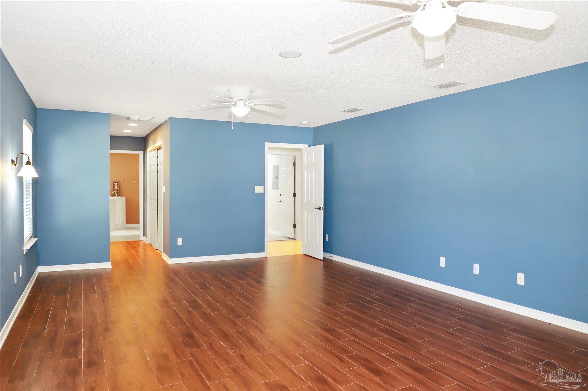 4454 Lyons Place Holt, FL 32564 - Photo 25 of 53 a view of an empty room with window and wooden floor