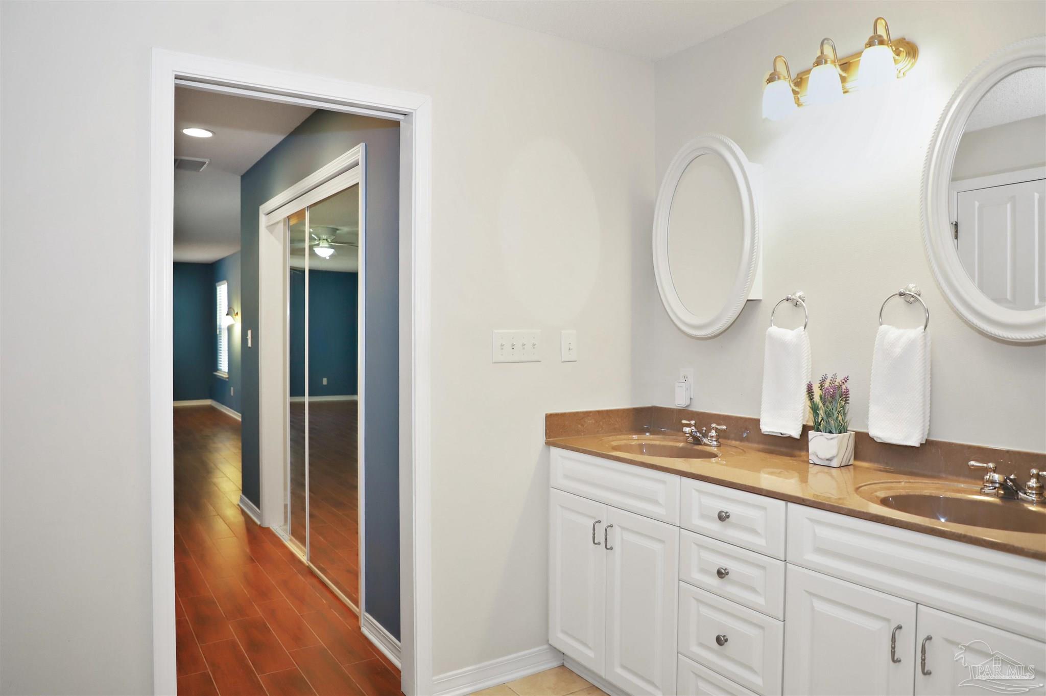 4454 Lyons Place Holt, FL 32564 - Photo 28 of 53 a bathroom with a granite countertop sink and a mirror