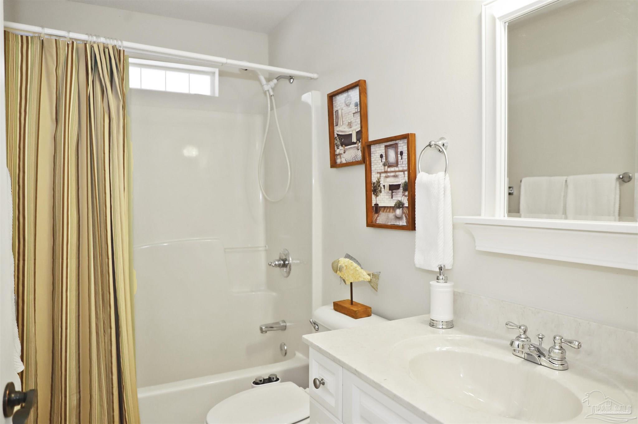 4454 Lyons Place Holt, FL 32564 - Photo 29 of 53 a bathroom with a sink toilet and shower