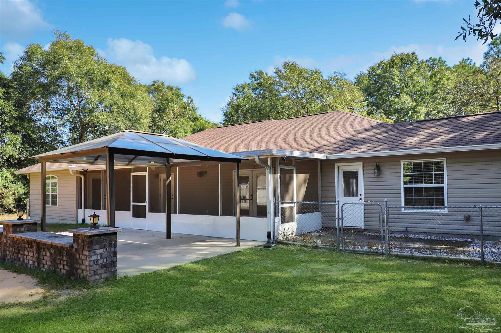 4454 Lyons Place Holt, FL 32564 - Photo 39 of 53 a view of a house with a backyard
