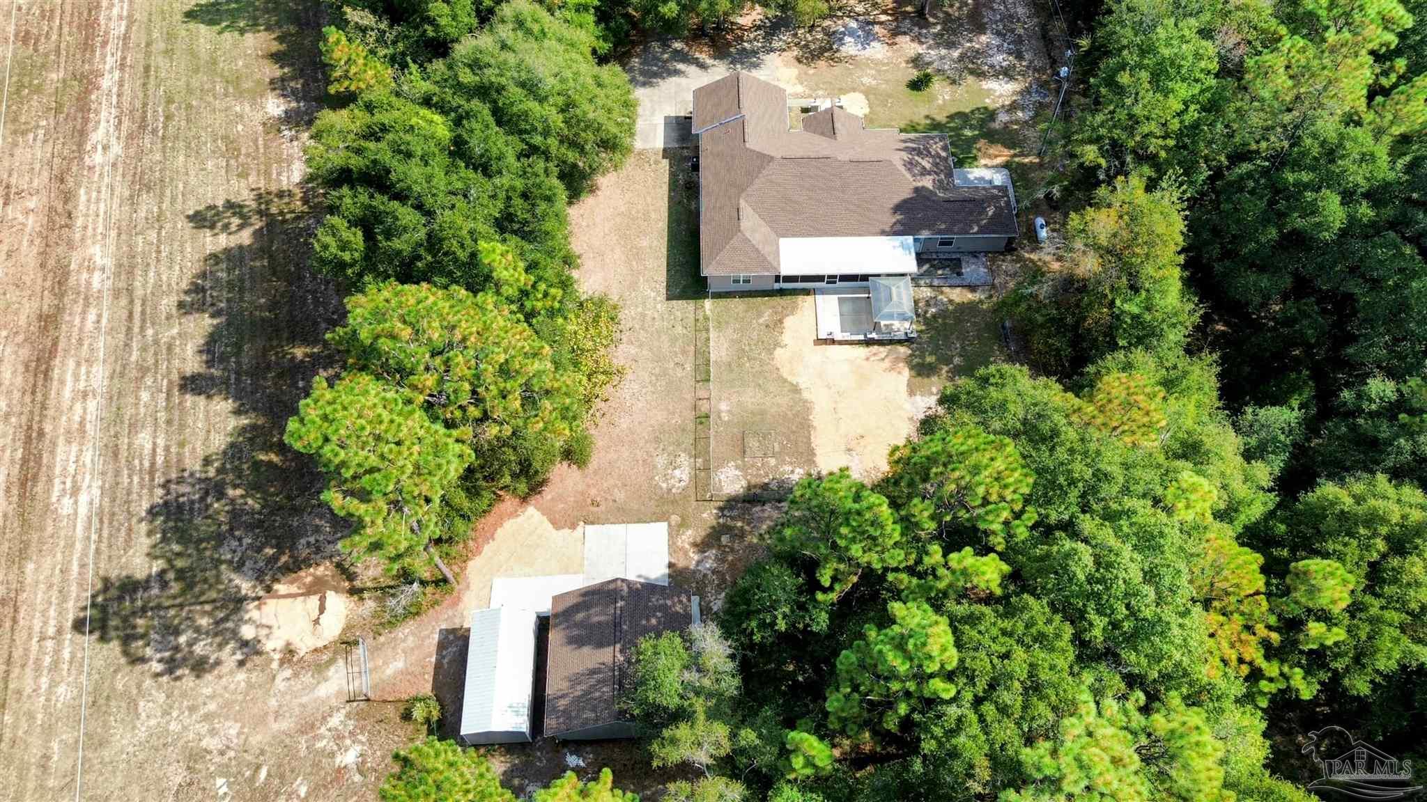 4454 Lyons Place Holt, FL 32564 - Photo 4 of 53 an aerial view of a house with a yard and garden