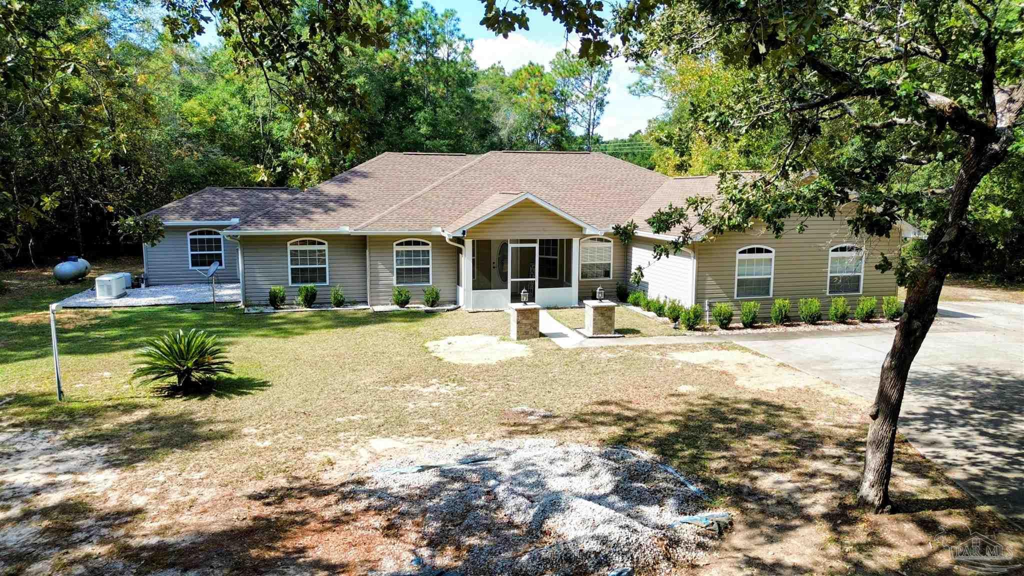4454 Lyons Place Holt, FL 32564 - Photo 48 of 53 a front view of a house with a yard
