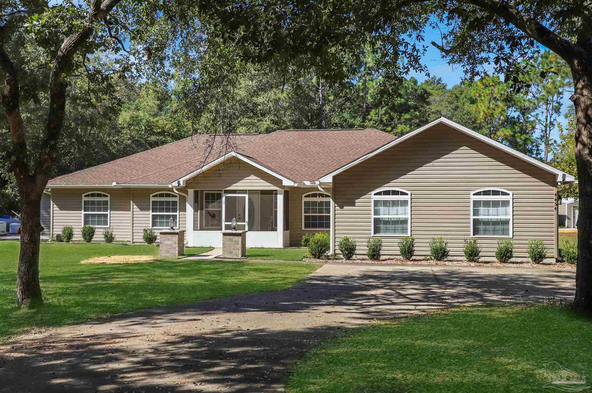 4454 Lyons Place Holt, FL 32564 - Photo 49 of 53 a front view of a house with a yard
