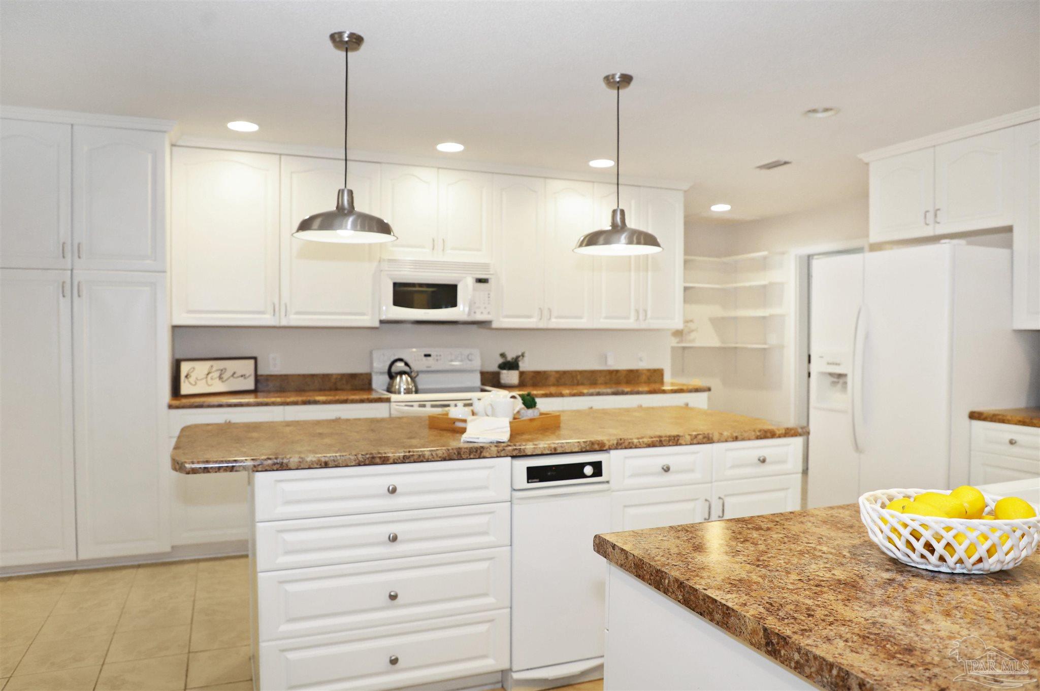 4454 Lyons Place Holt, FL 32564 - Photo 6 of 53 a kitchen with stainless steel appliances granite countertop a sink a stove and a refrigerator