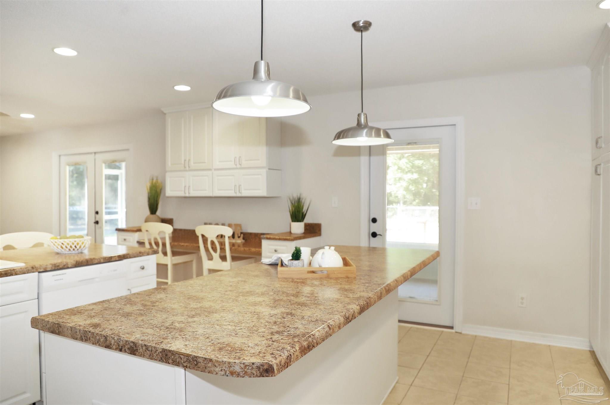 4454 Lyons Place Holt, FL 32564 - Photo 7 of 53 a kitchen with kitchen island a center island and a chandelier