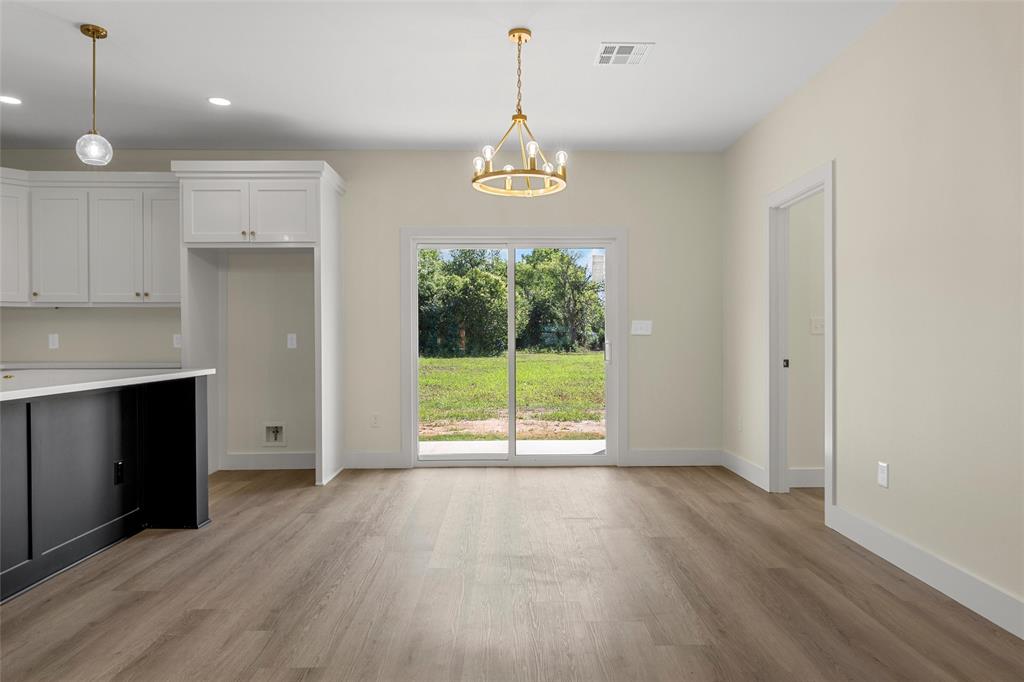 3320 North 27th Street Waco, TX 76708 - Photo 14 of 38 a view of an empty room with wooden floor and a window