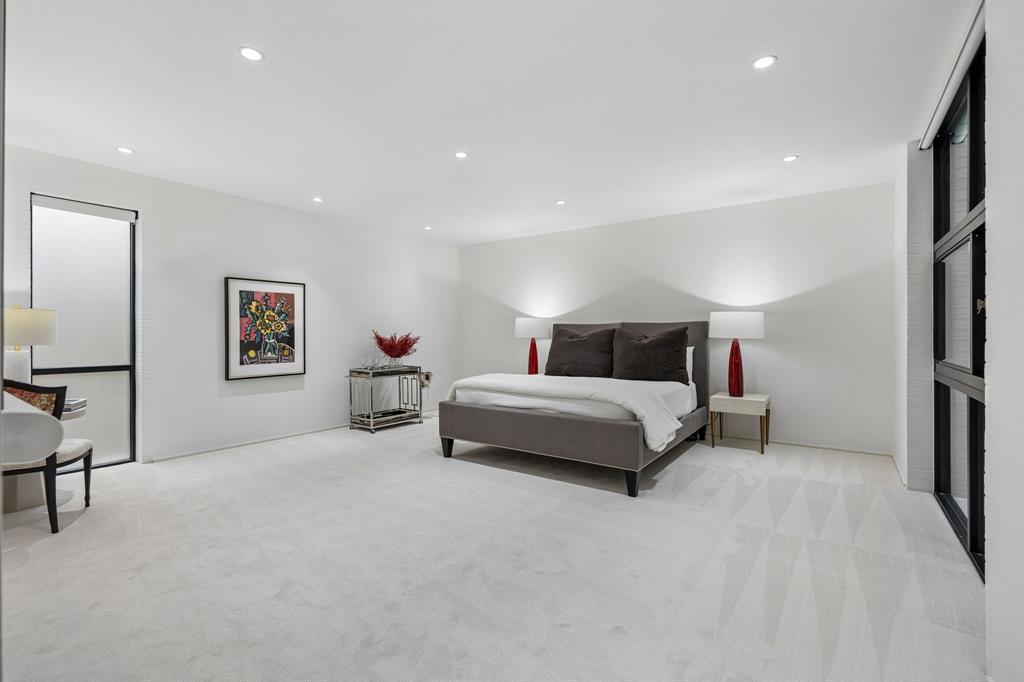 4321 Travis Street Dallas, TX 75205 - Photo 18 of 40 a bedroom with a bed and a lamp with table