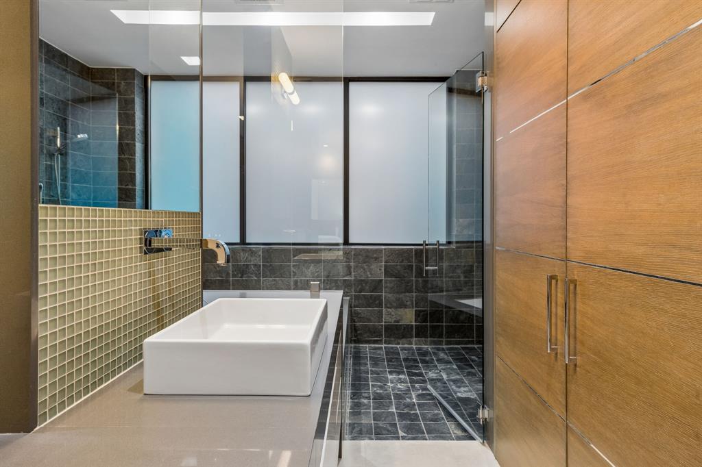 4321 Travis Street Dallas, TX 75205 - Photo 25 of 40 a bathroom with a bathtub and a shower