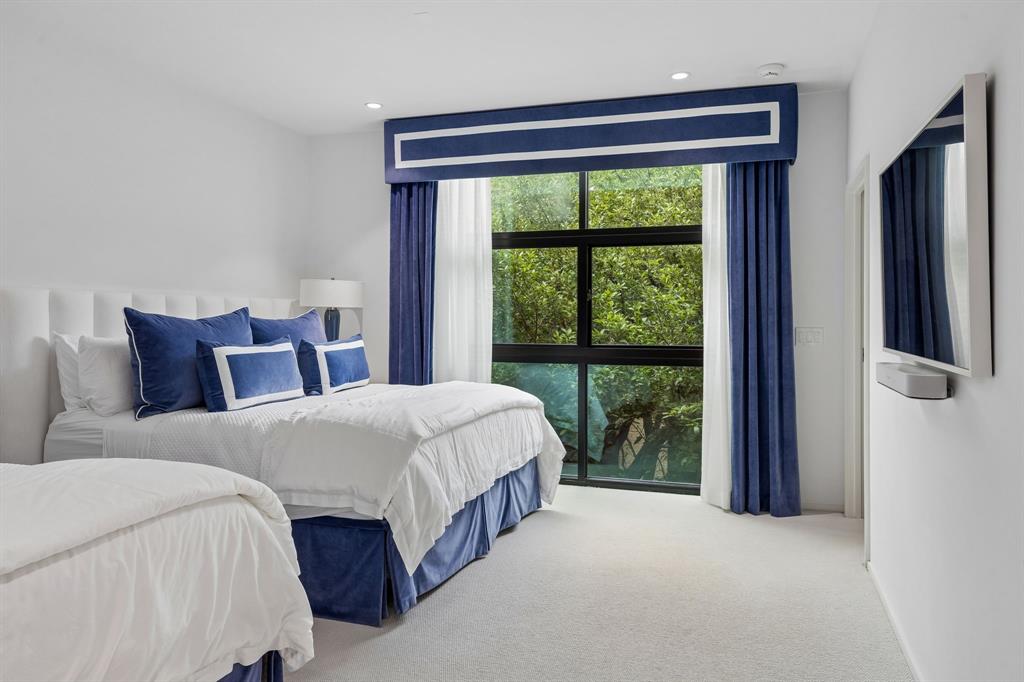 4321 Travis Street Dallas, TX 75205 - Photo 31 of 40 a bedroom with a large bed and a large window