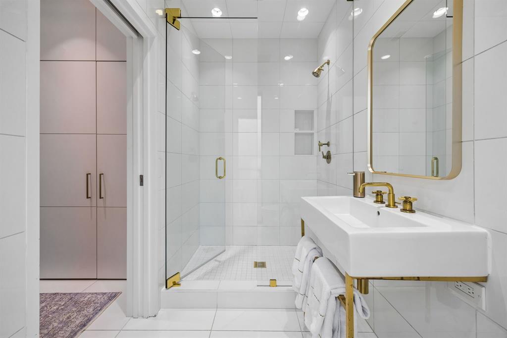 4321 Travis Street Dallas, TX 75205 - Photo 34 of 40 a bathroom with a sink a toilet and shower