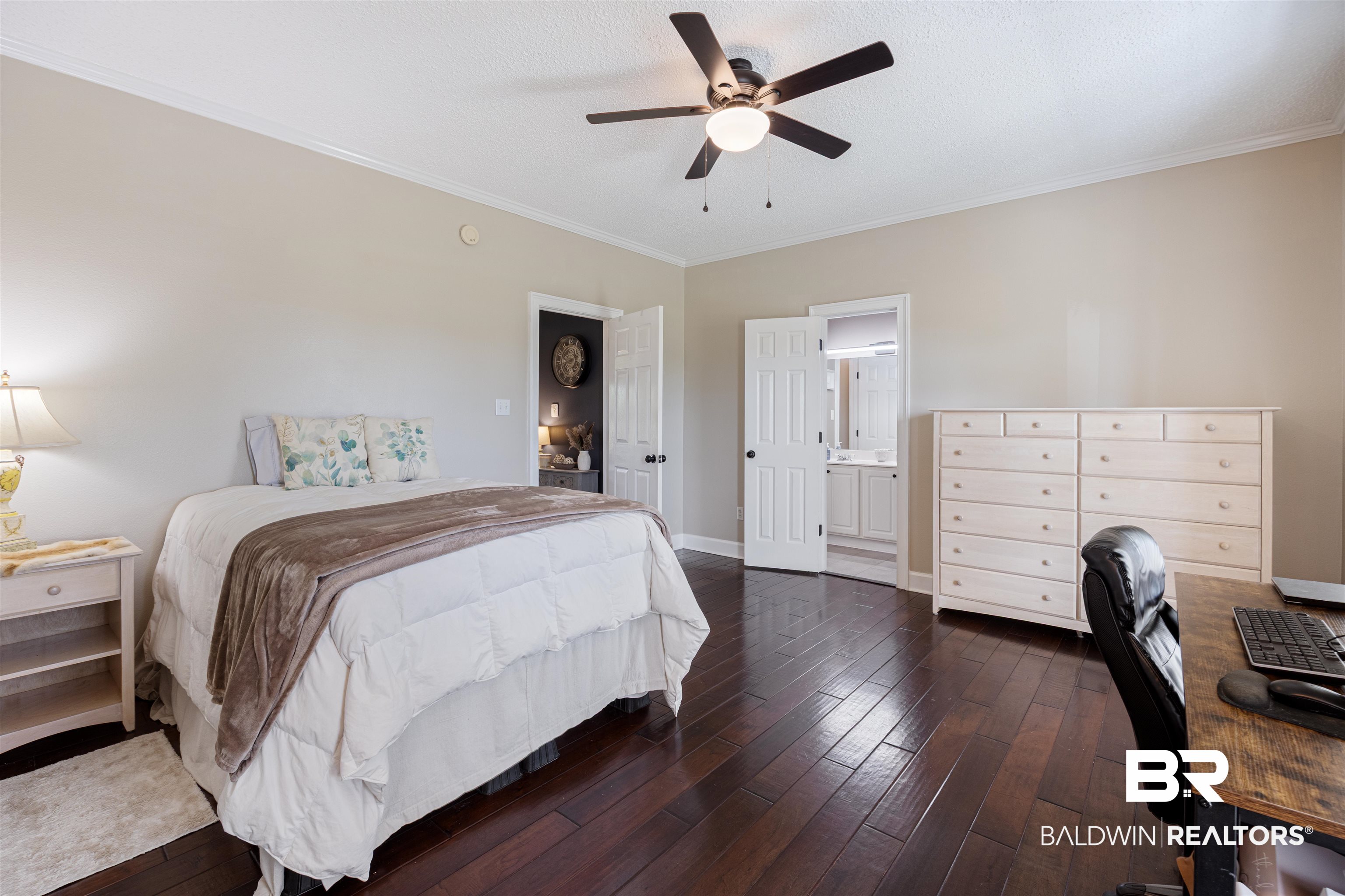 9855 Stucki Road Elberta, AL 36530 - Photo 44 of 54 Bedroom with dark wood-style flooring, ceiling fan, ornamental molding, an office area, and a textured ceiling