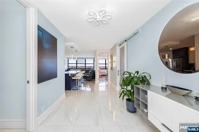 a spacious bathroom with a double vanity sink a mirror and a shower