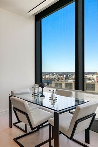 a view of a dining room with furniture and window