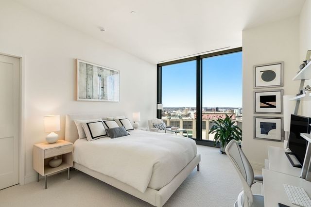 a bedroom with a large bed and a tv