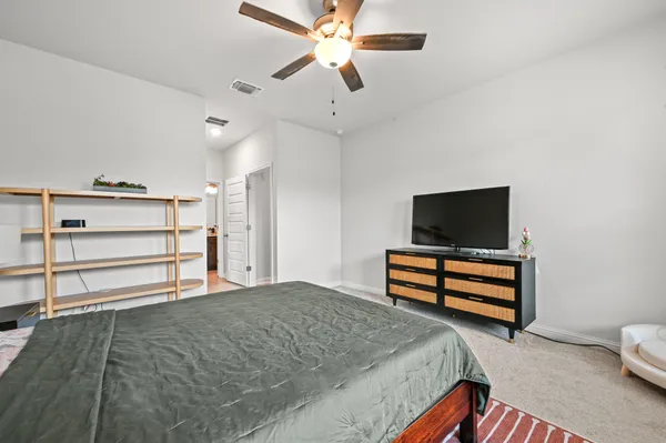 a bedroom with a bed and a flat screen tv