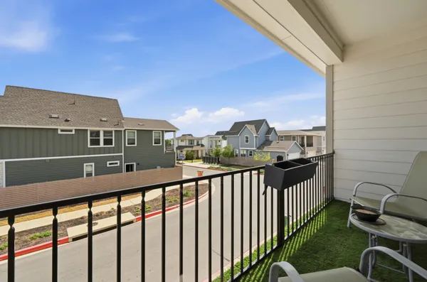 a view of a balcony with chairs