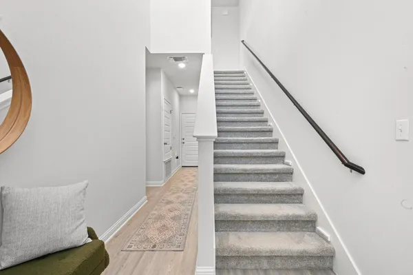 a view of entryway and hall with wooden floor