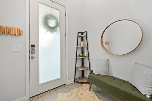 a living room with a mirror and a glass door