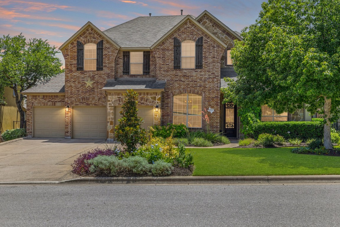a front view of a house with a yard and garage