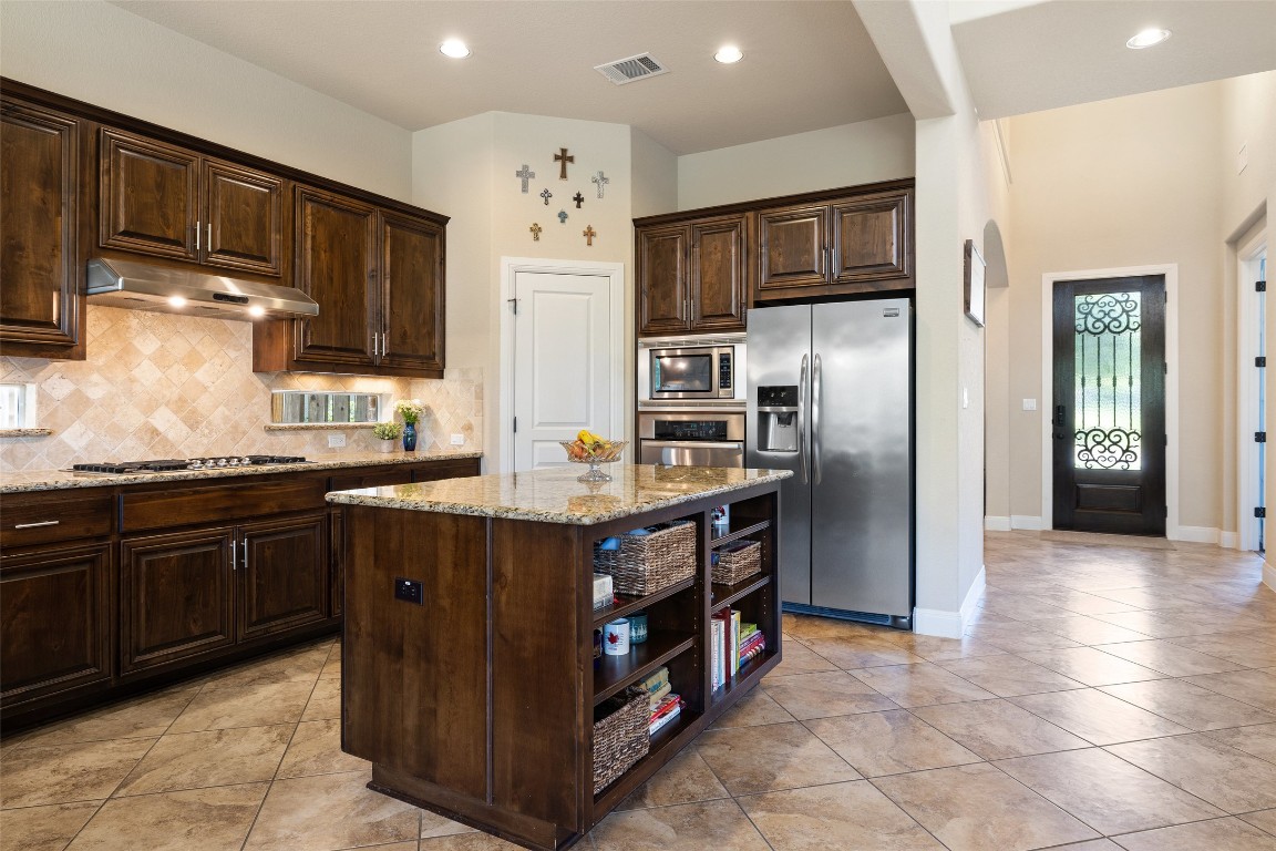 8709 Fescue Lane Austin, TX 78738 - Photo 11 of 36 a kitchen with stainless steel appliances granite countertop a refrigerator and a sink