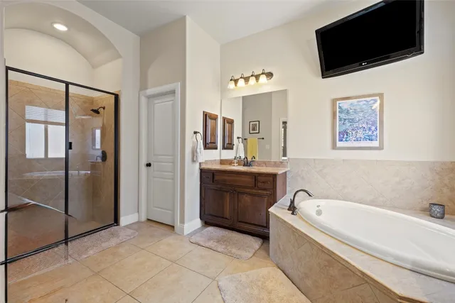 a spacious bedroom with a bed and a large window