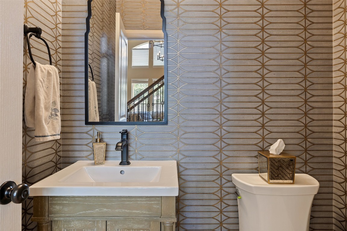 8709 Fescue Lane Austin, TX 78738 - Photo 16 of 36 a bathroom with a toilet a sink and mirror