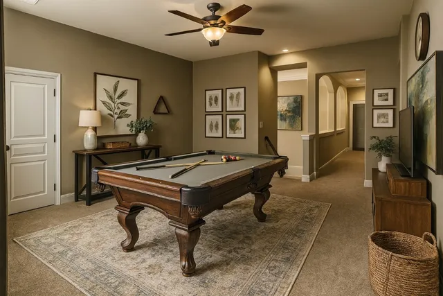 a living room with furniture a flat screen tv and a table
