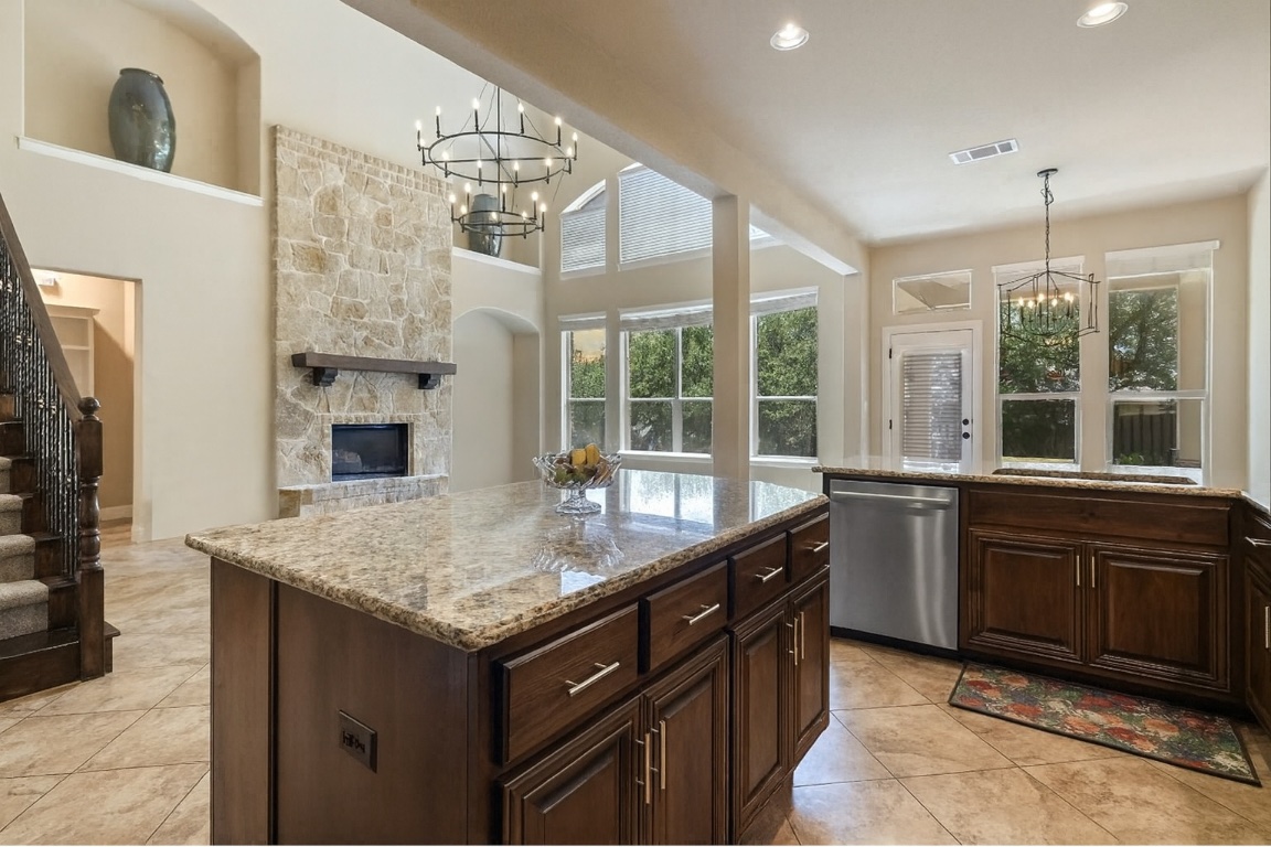 8709 Fescue Lane Austin, TX 78738 - Photo 36 of 36 Featuring a stunning open floor plan for the gourmet island kitchen and living room with oversized windows lining the back wall for maximum natural light.