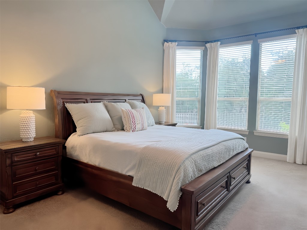 8709 Fescue Lane Austin, TX 78738 - Photo 4 of 36 a bed sitting in a bedroom next to a window