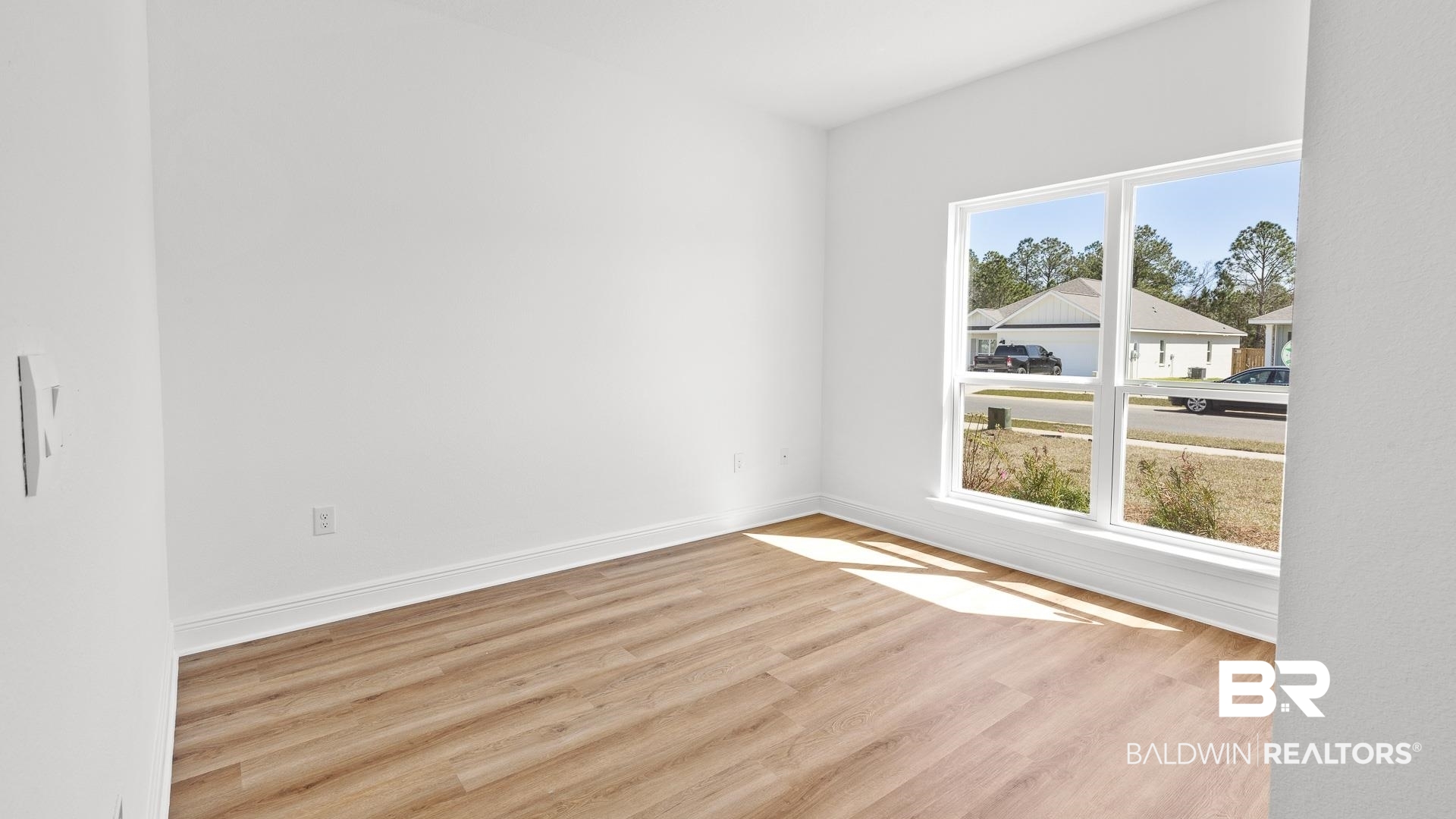 12931 Grand Rpds Road Fairhope, AL 36532 - Photo 7 of 33 Empty room featuring wood finished floors and baseboards