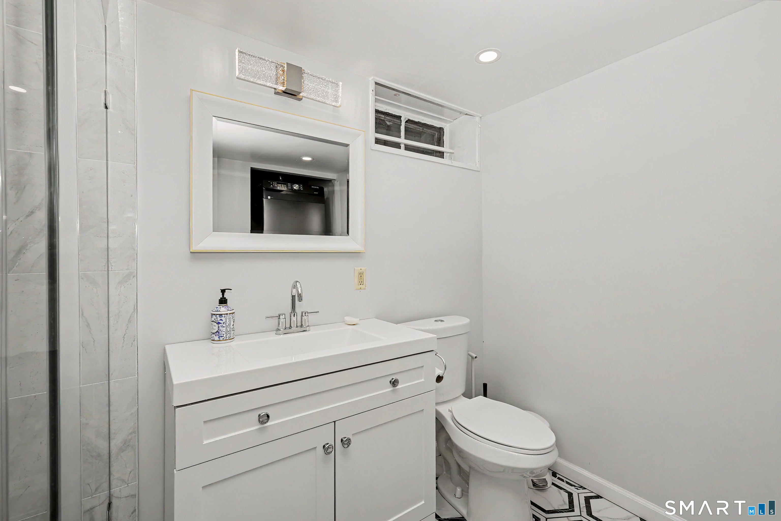44 Haverhill Road Trumbull, CT 06611 - Photo 16 of 32 a bathroom with a toilet sink and mirror