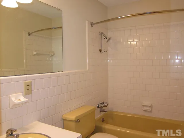 a bathroom with a shower and a toilet