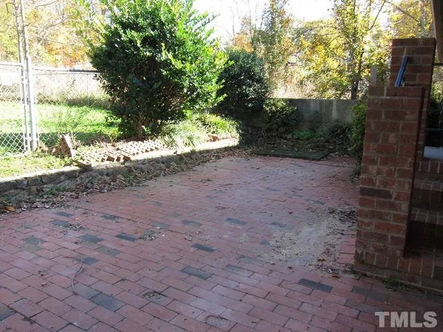 a view of a dirt road with a tree in the background