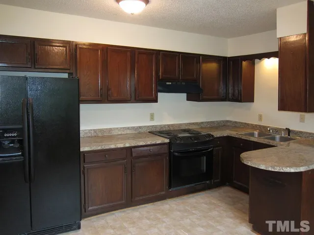a kitchen with a sink and a refrigerator