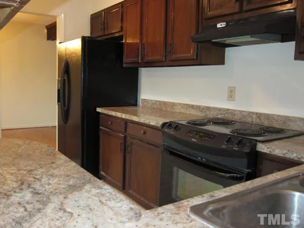 a stove top oven sitting inside of a kitchen